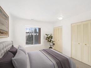 East Lansing townhouse for rent - a bedroom with a large bed and a large window