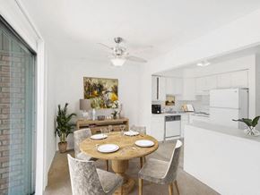East Lansing townhouse for rent - a dining area with a table and chairs and a kitchen in the background