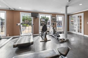 Affton apartment for rent - A gym with treadmills, elliptical machines, and a weight bench.