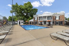 Affton apartment for rent - A pool area with sun loungers and a building in the background.
