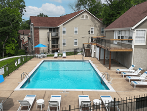 Oakville apartment for rent - A swimming pool surrounded by lounge chairs and apartment buildings.