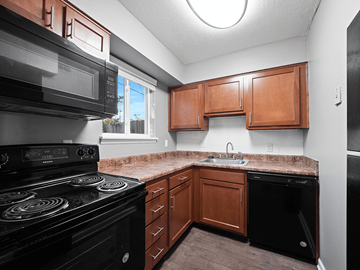 Clarksville apartment for rent - a kitchen with black appliances and a granite counter top