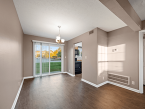 Clarksville apartment for rent - an empty living room with a sliding glass door to a yard