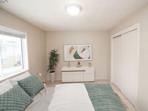 Sioux City apartment for rent - a bedroom with a large bed next to a window