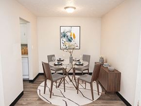 Sioux City apartment for rent - a dining room with a table and chairs and a painting on the wall