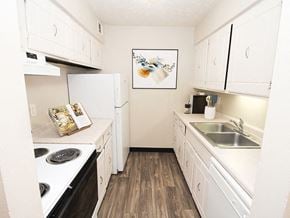 Sioux City apartment for rent - a kitchen with white cabinets and appliances