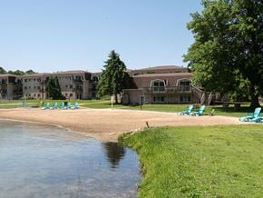 Grand Rapids apartment for rent - an empty beach with chairs and buildings in the background