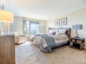 Duluth apartment for rent - A bedroom with a large bed and a window overlooking the ocean.