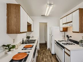 Pueblo apartment for rent - galley style kitchen with oven and dishwasher at mesa gardens apartment