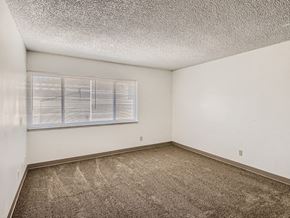 Pueblo apartment for rent - Living room with large window at mesa gardens apartments