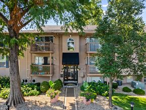 Lenexa apartment for rent - front view of an apartment building with trees and a pathway