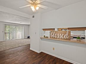 Lenexa apartment for rent - an empty living room with a sign on the wall