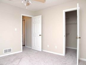 Topeka townhouse for rent - an empty bedroom with a closet and a white door