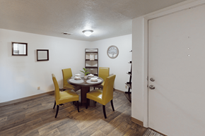 Albuquerque apartment for rent - A dining room with a table set for two and yellow chairs.