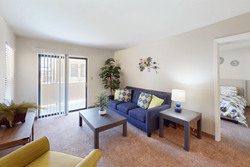 Albuquerque apartment for rent - A living room with a blue couch and a yellow chair.