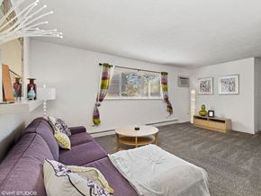 Fairborn apartment for rent - a living room with a purple couch and a table