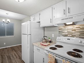 Topeka townhouse for rent - a kitchen with white appliances and white cabinets
