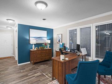 Topeka townhouse for rent - a living room with a desk and a chair