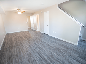 Mcpherson apartment for rent - A room with a ceiling fan and wood flooring.