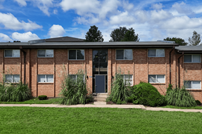 St. Louis apartment for rent - A red brick building with a black door and windows.