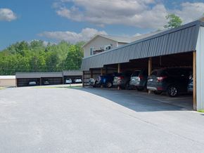 Marquette apartment for rent - a parking lot with cars in it and a building in the background