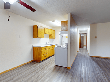 St. Cloud apartment for rent - A kitchen with wooden cabinets and a white counter.