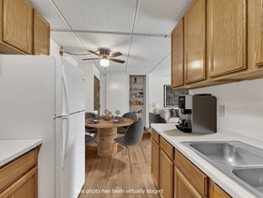 Rochester apartment for rent - a kitchen with a dining table and a refrigerator