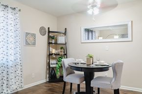 Omaha apartment for rent - A dining room with a table set for two and a mirror above it.