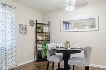 Omaha apartment for rent - A dining room with a table set for two and a mirror above it.