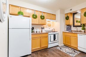 Omaha apartment for rent - A kitchen with wooden cabinets and a white fridge.