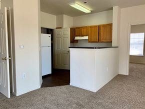 Amarillo apartment for rent - a kitchen with a white refrigerator freezer next to a doorway