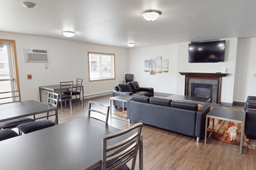 Watford City apartment for rent - A living room with a fireplace and a television mounted on the wall.