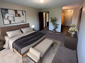 Waite Park apartment for rent - a bedroom with a large bed and a large painting on the wall