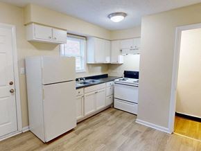 Louisville apartment for rent - Apartment kitchen with white appliances and cabinets