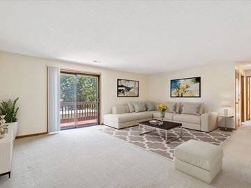 Cedar Rapids apartment for rent - a living room with white furniture and a sliding glass door