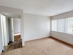 Florissant townhouse for rent - A room with a carpeted floor and a doorway leading to another room.