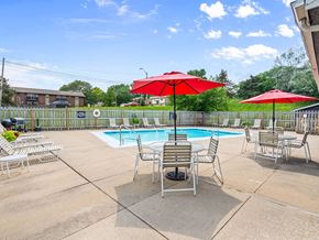 Kansas City townhouse for rent - a pool with chairs and umbrellas next to a pool