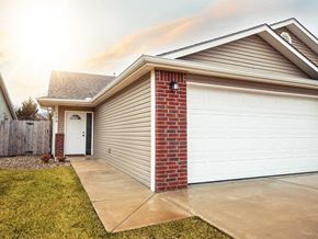 Valley Center triplex for rent - a home with a white garage door and a driveway