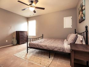 Valley Center triplex for rent - a bedroom with a bed and a ceiling fan