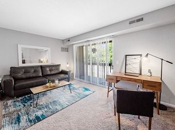 Davison apartment for rent - a living room with a couch and a desk