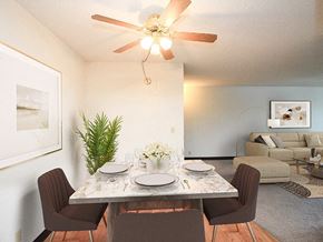 Sioux City apartment for rent - a dining room with a table and chairs and a ceiling fan