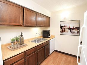 Sioux City apartment for rent - a kitchen with wooden cabinets and a sink