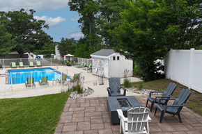 Grand Rapids townhouse for rent - A backyard with a pool, patio furniture, and a white fence.