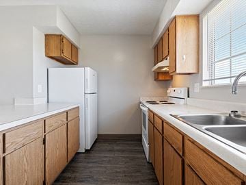 Fremont apartment for rent - A kitchen with wooden cabinets and white appliances.