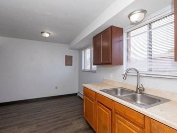 Sandusky apartment for rent - A kitchen with wooden cabinets and a stainless steel sink.