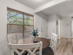 Roswell apartment for rent - a dining room with a table and chairs and a window
