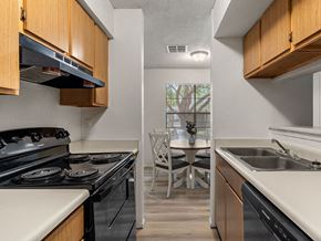 Roswell apartment for rent - a kitchen with a stove and a sink and a table
