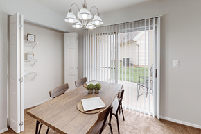 Florissant apartment for rent - A dining room with a wooden table and chairs.