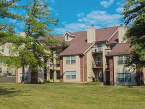 Florissant apartment for rent - A large apartment complex with a grassy area in front.