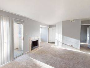 Florissant apartment for rent - A living room with a fireplace and a carpet.